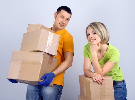 Local moving team handling boxes in a Harrow flat