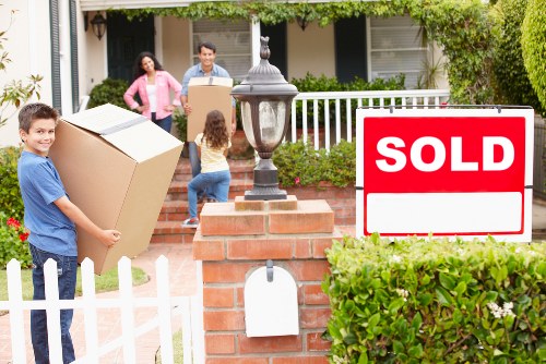 Careful loading of boxed household items for a flat removal in Harrow